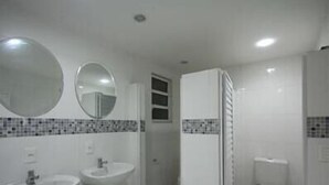 A bathroom with a sink, mirror, and toilet.