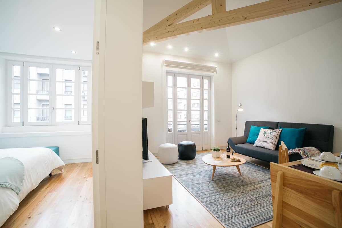 A modern living room with a sofa, coffee table, and a television.