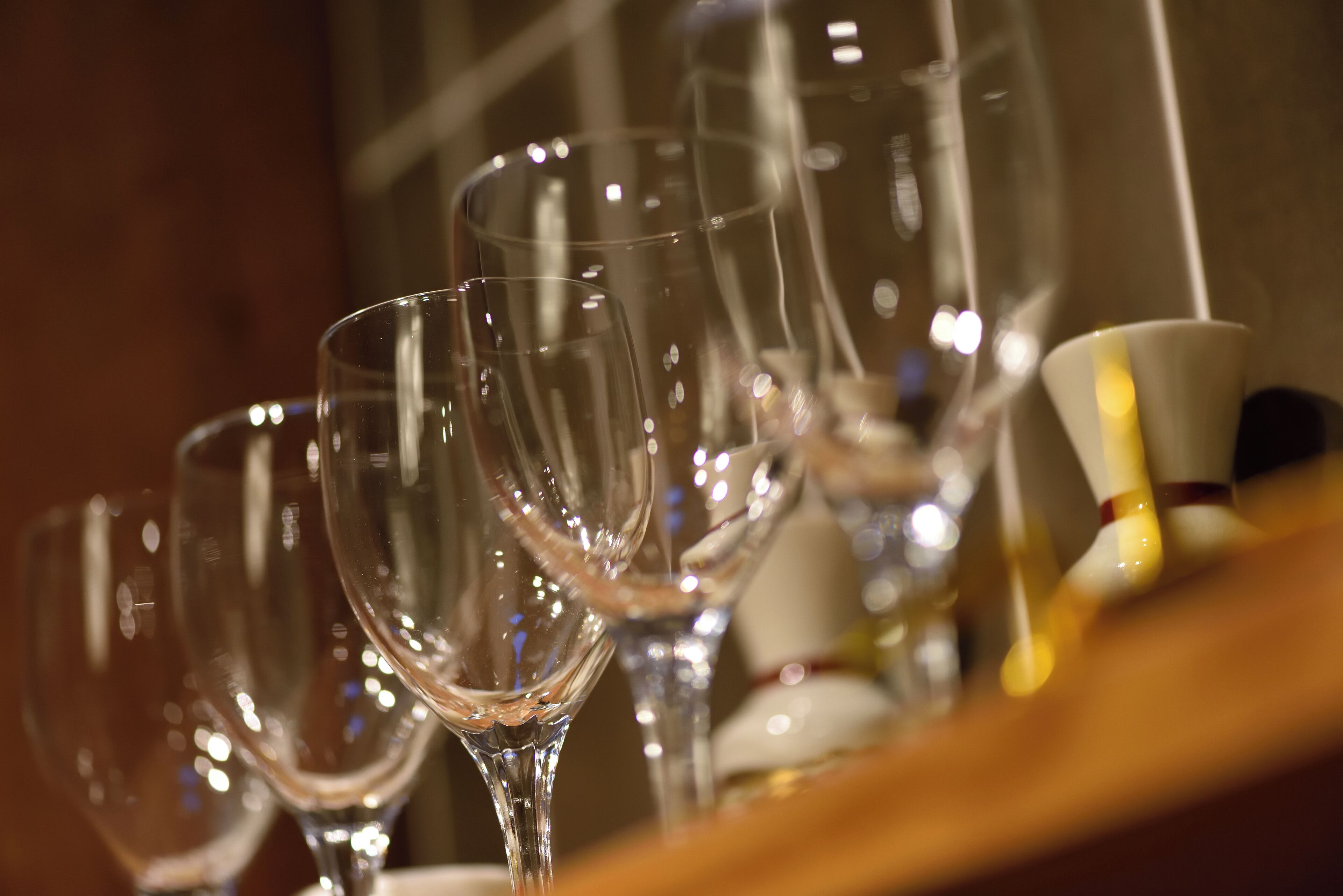A row of empty wine glasses on a table.