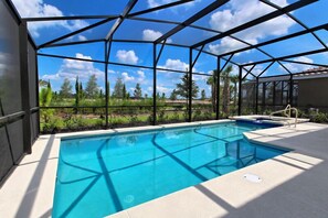 A swimming pool with a clear view of the surrounding landscape, enclosed by a metal frame structure. - 4412AC (Davenport)
