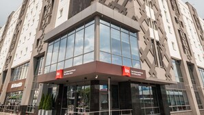 A modern building with a glass facade, a distinctive geometric pattern on the side, and signage for 'Kiev Railway Station.' - ibis Kyiv Railway Station (Kyiv)