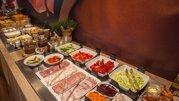A buffet with various food options including meats, cheeses, fruits, and salads. - ibis Kyiv Railway Station (Kyiv)