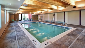 An indoor swimming pool with wooden ceiling beams, clear water, and marked depth lines. - Home2 Suites by Hilton Mechanicsburg (Mechanicsburg)