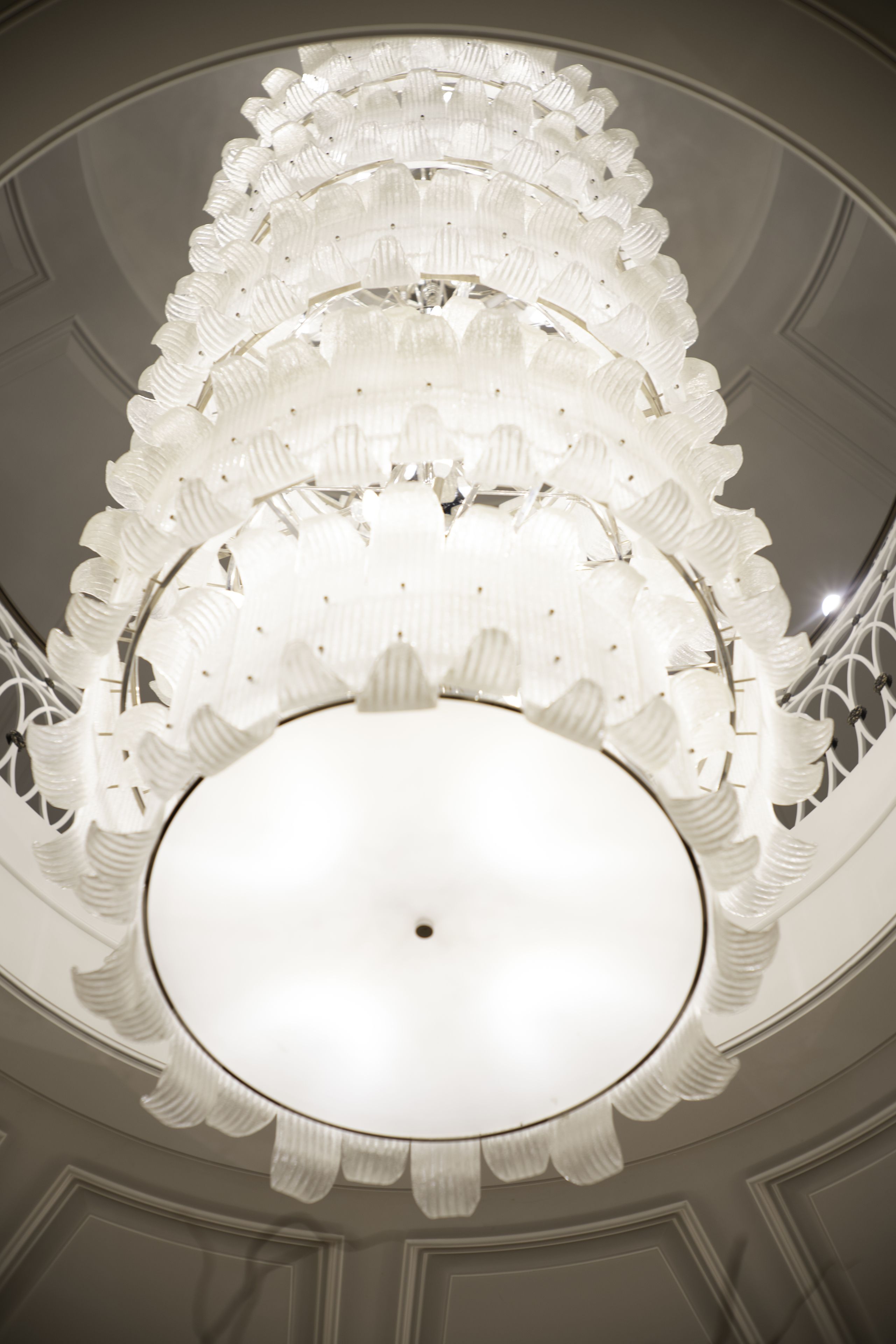 A ceiling with a circular, ribbed design and a central light fixture.