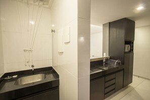 Bathroom features a double sink, mirror, and microwave.