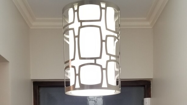 A wooden door with a modern pendant light fixture above it. - New Kingston Guest Apartment at Eight (Kingston)