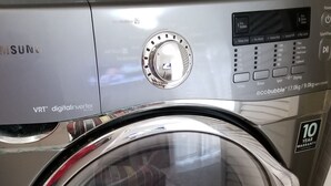 A front view of a Samsung VRT digital inverter washing machine with a 10-year warranty. - New Kingston Guest Apartment at Eight (Kingston)