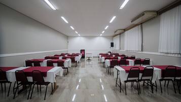 A conference room with tables and chairs arranged for a meeting.