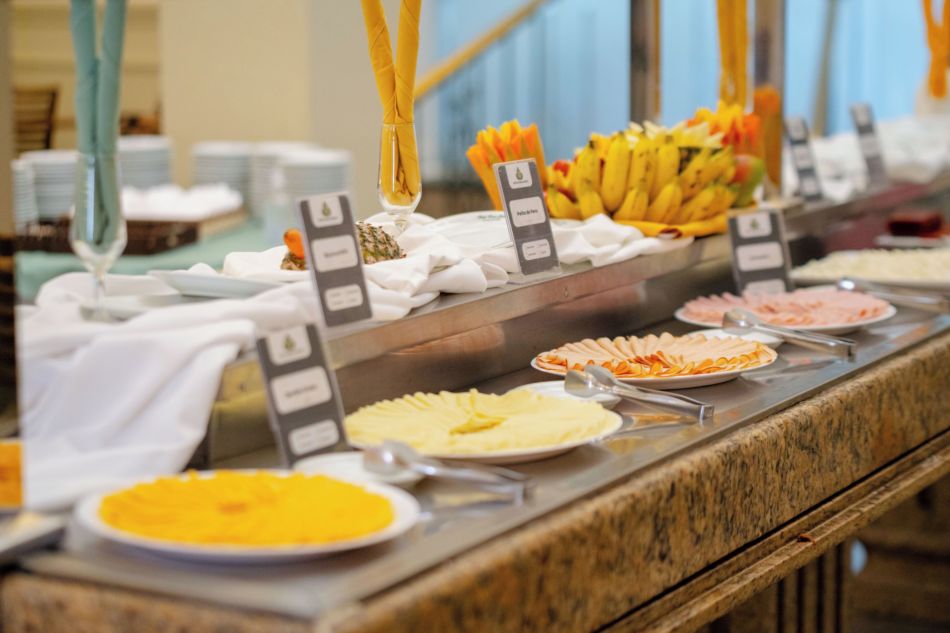 A buffet with various food items and serving utensils.