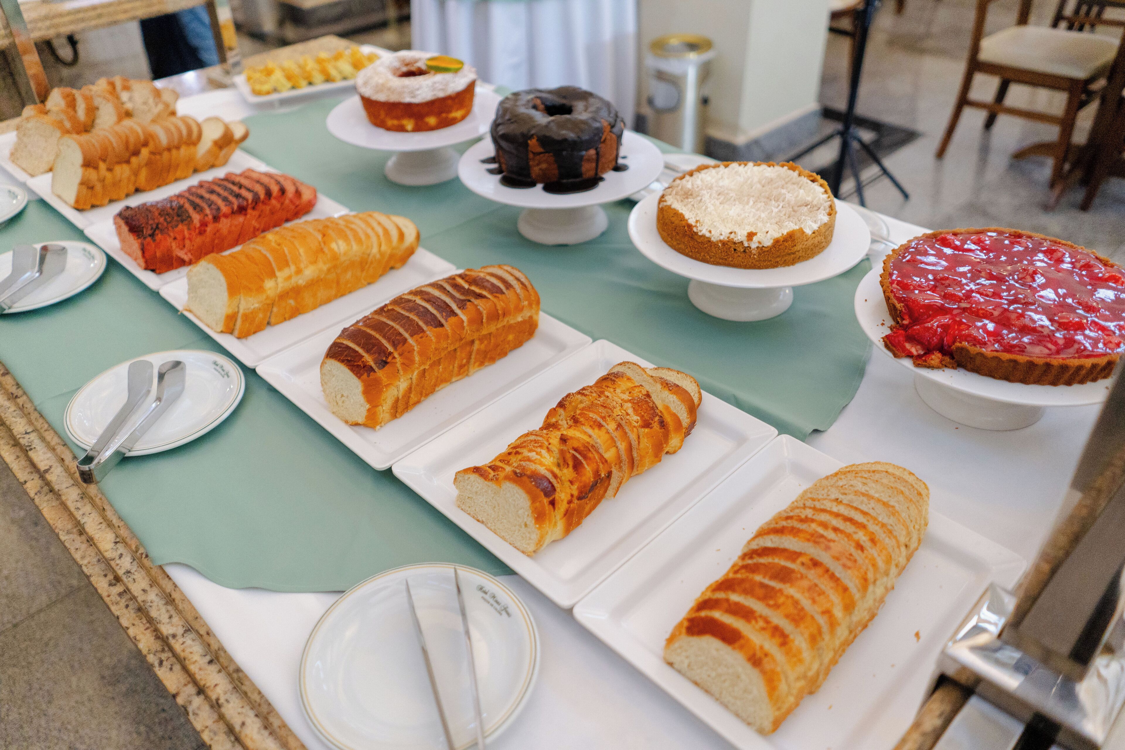 A table with various types of bread and pastries.