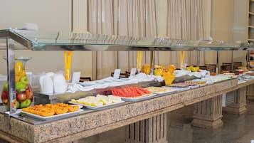 A buffet setup with various food items and a glass display case.