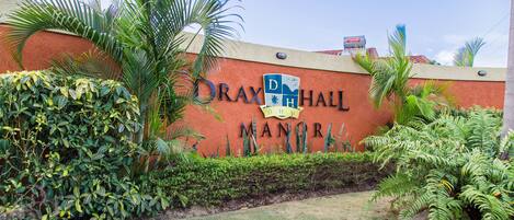 A building with a sign that reads "DRAX HALL MANOR".