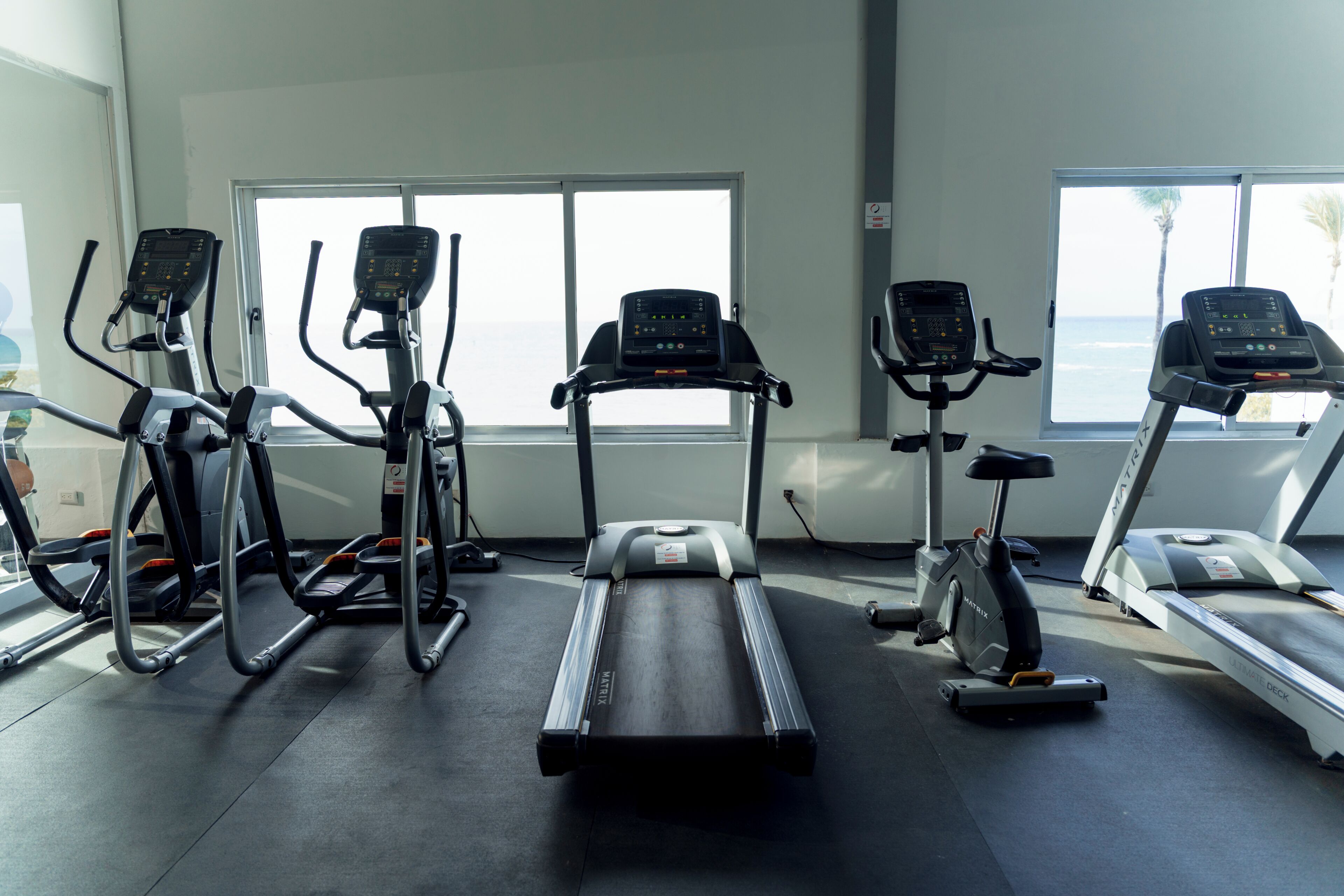 A gym with treadmills, ellipticals, and stationary bikes.