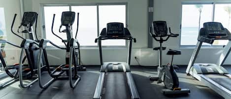 A gym with treadmills, ellipticals, and stationary bikes.
