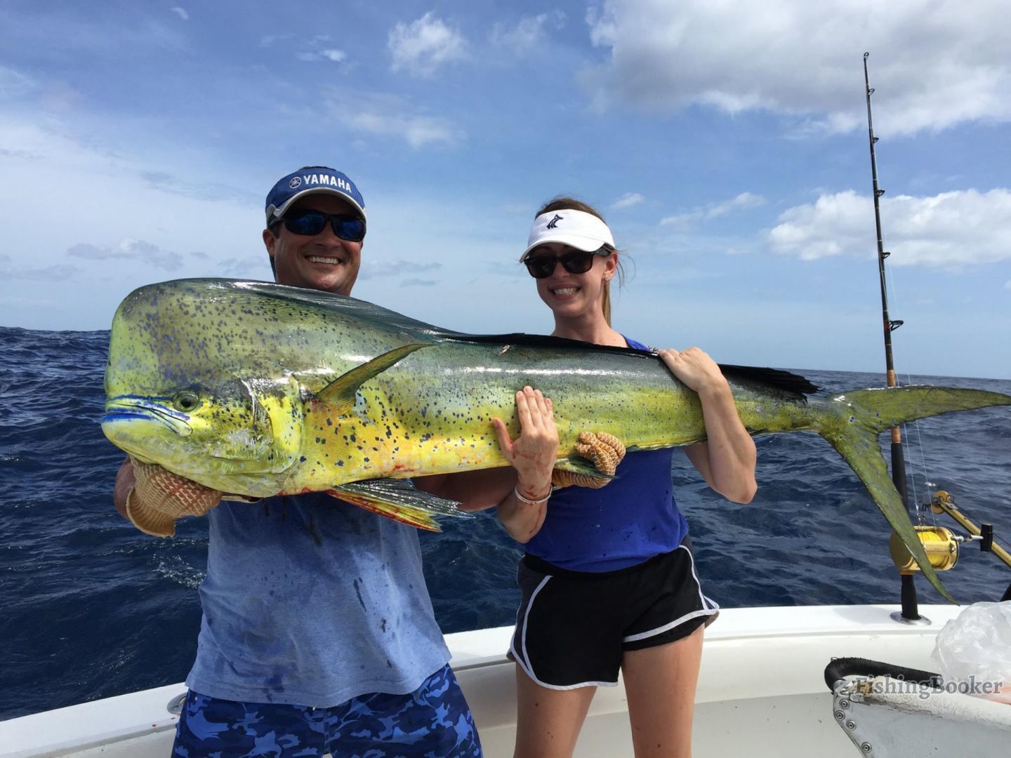 A person holding a large fish on a boat.