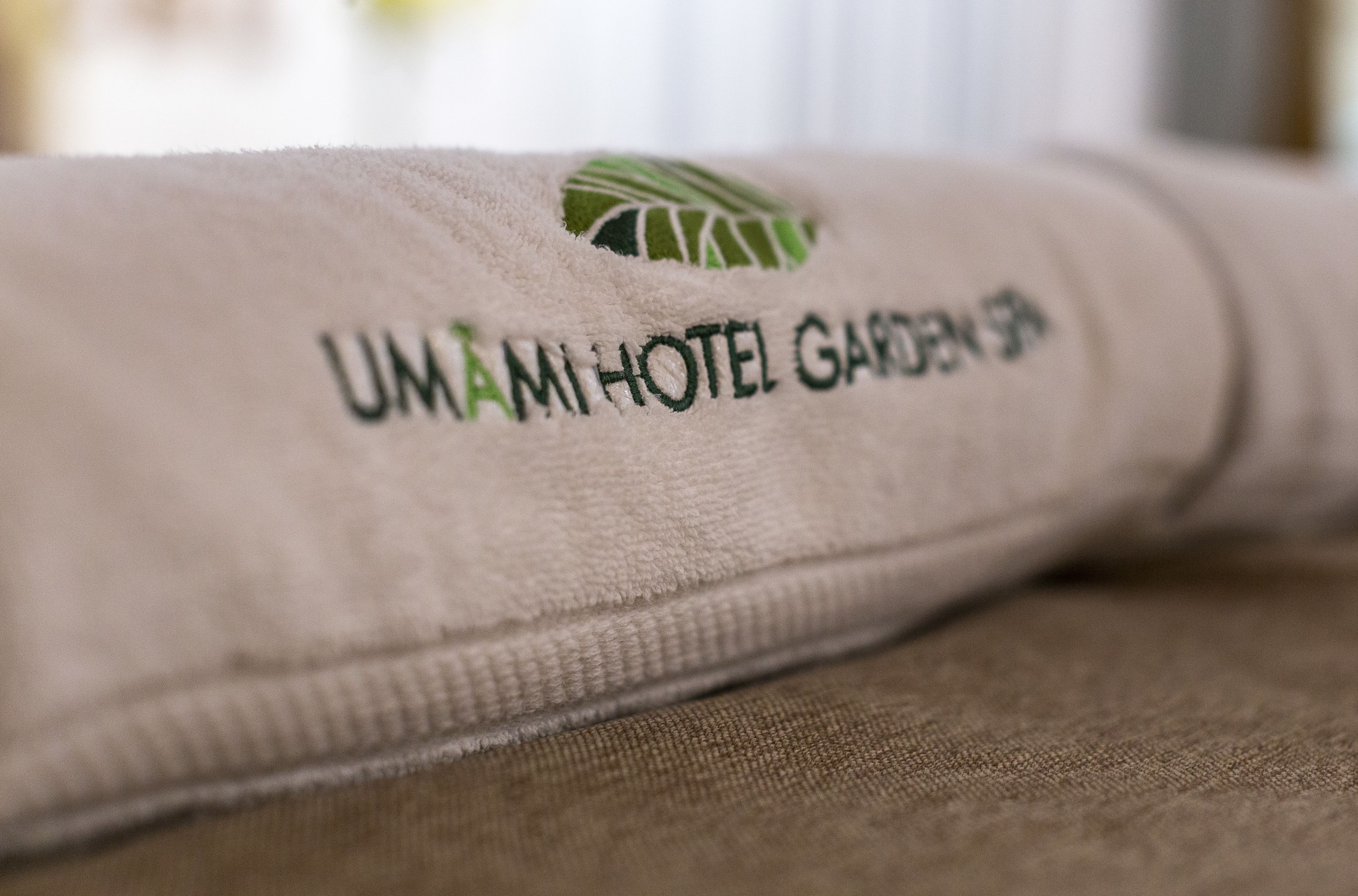 A towel with the text "UMAMI HOTEL GARDEN 39".