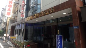 A hotel with a modern facade, large glass windows, and a prominent sign indicating it is the Hotel Sun Targa. - Hotel SUNTARGAS UENO (Tokyo)