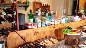 A breakfast bar with a menu, condiments, and various food items. - Palazzo Pavone Gallery & Resort (Pak Chong)