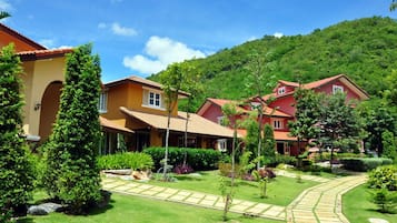 A residential area with houses, a well-maintained lawn, and a clear sky.