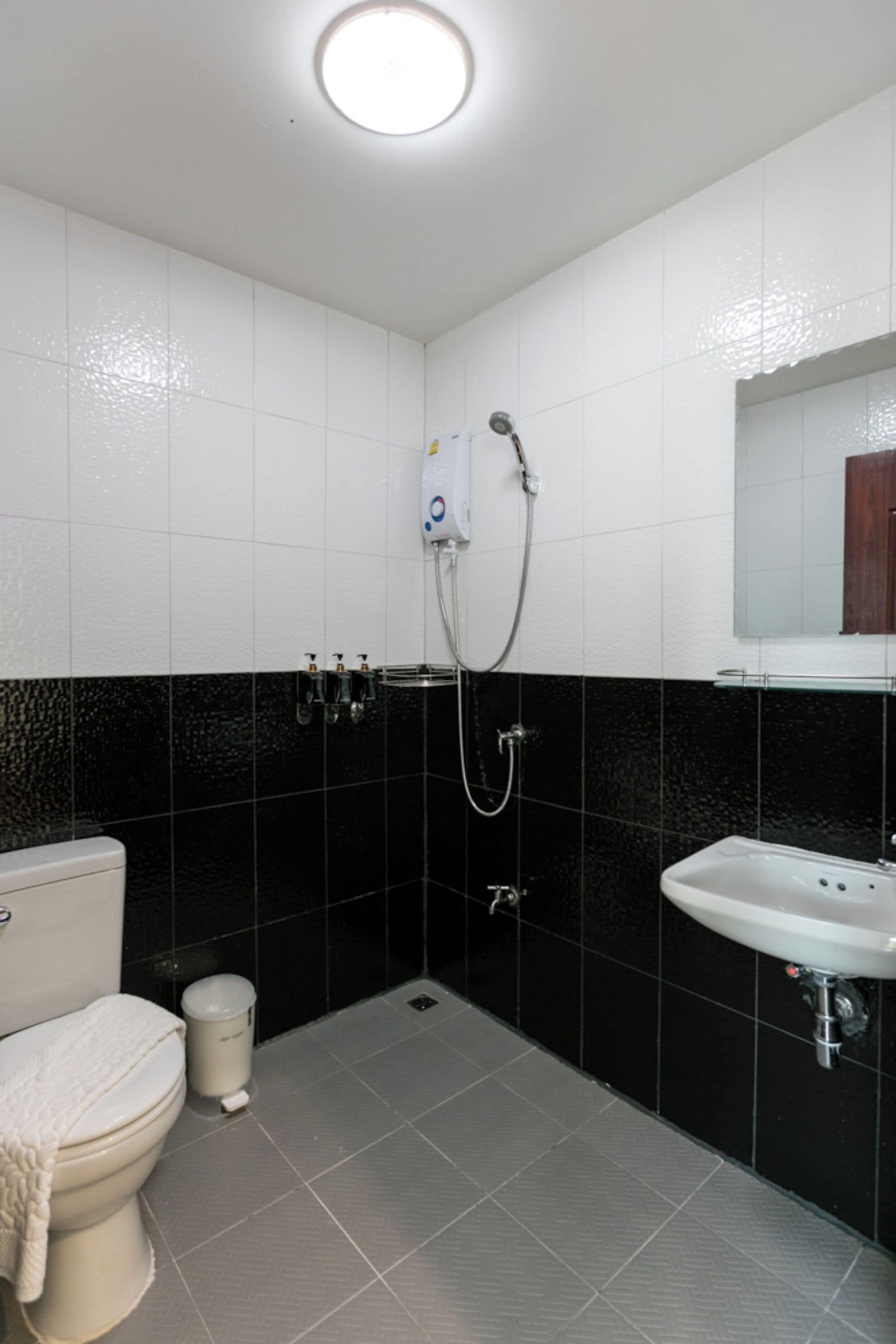 A bathroom with a toilet, sink, and shower.