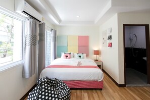 A hotel room with a bed, a window with curtains, a bedside table with a lamp, and a shower area. - Bangkok River Loka Hotel (Bangkok)