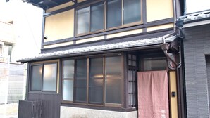A traditional Japanese building with a two-story structure, large windows, and a tiled roof. - Shounsai (Kyoto)