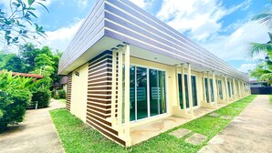 A modern building with a sloped roof and large glass windows. - Kuapa Resort (Takua Pa)