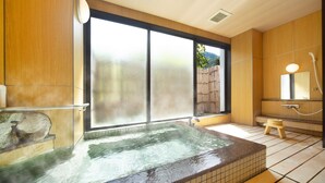 A modern bathroom with a large window, a hot tub, and a wooden interior. - Ooedo Onsen Monogatari Unazuki Grand Hotel (Kurobe)