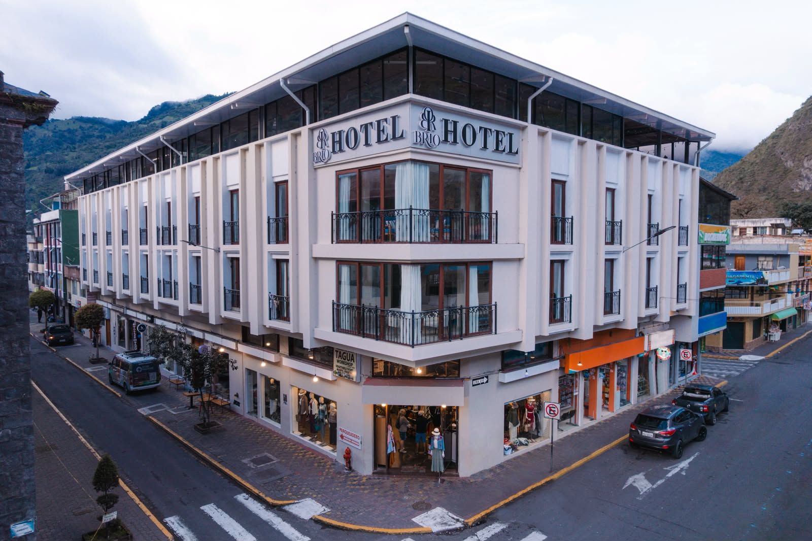 A multi-story hotel with a modern facade, large windows, and balconies.
