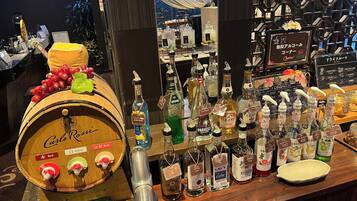 A bar area with a wooden barrel labeled "Carlo Rossi" and various bottles of liquor.