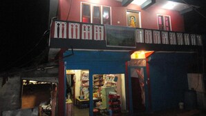 A two-story building with a balcony, a signboard, and a door. - Ram Homestay (Lekhnath)