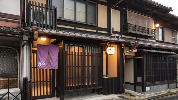 A traditional Japanese building with a wooden balcony, sliding doors, and a small awning. - Rinn Manjuji (Kyoto)