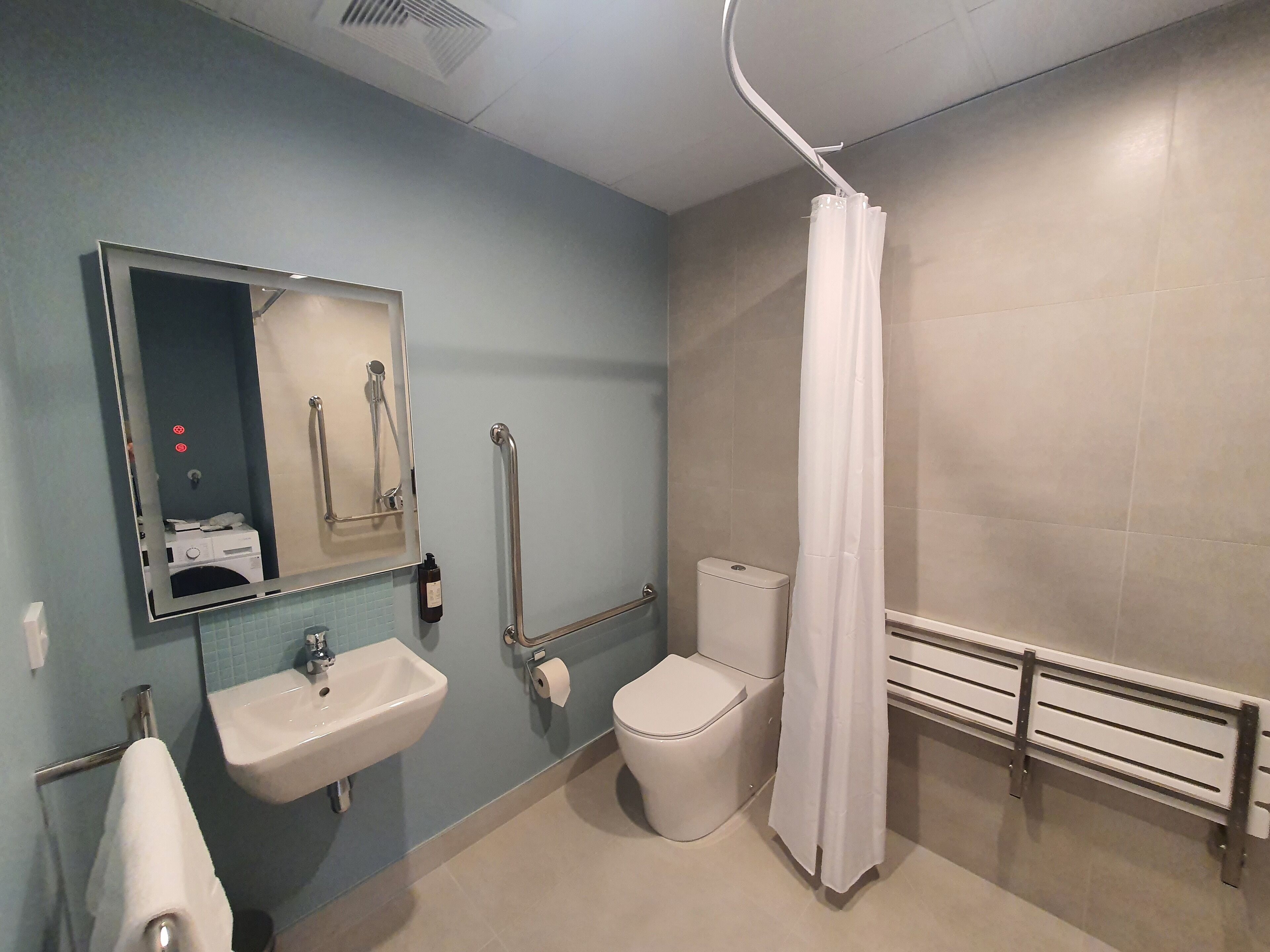 A bathroom with a sink, toilet, and shower.