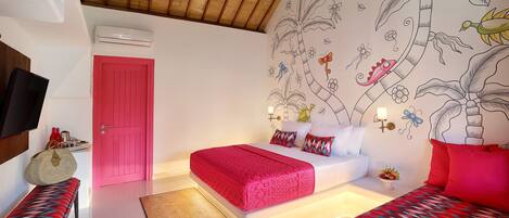 A hotel room with a wooden ceiling, a pink door, a bed with red bedding, a bench, and a wall mural.