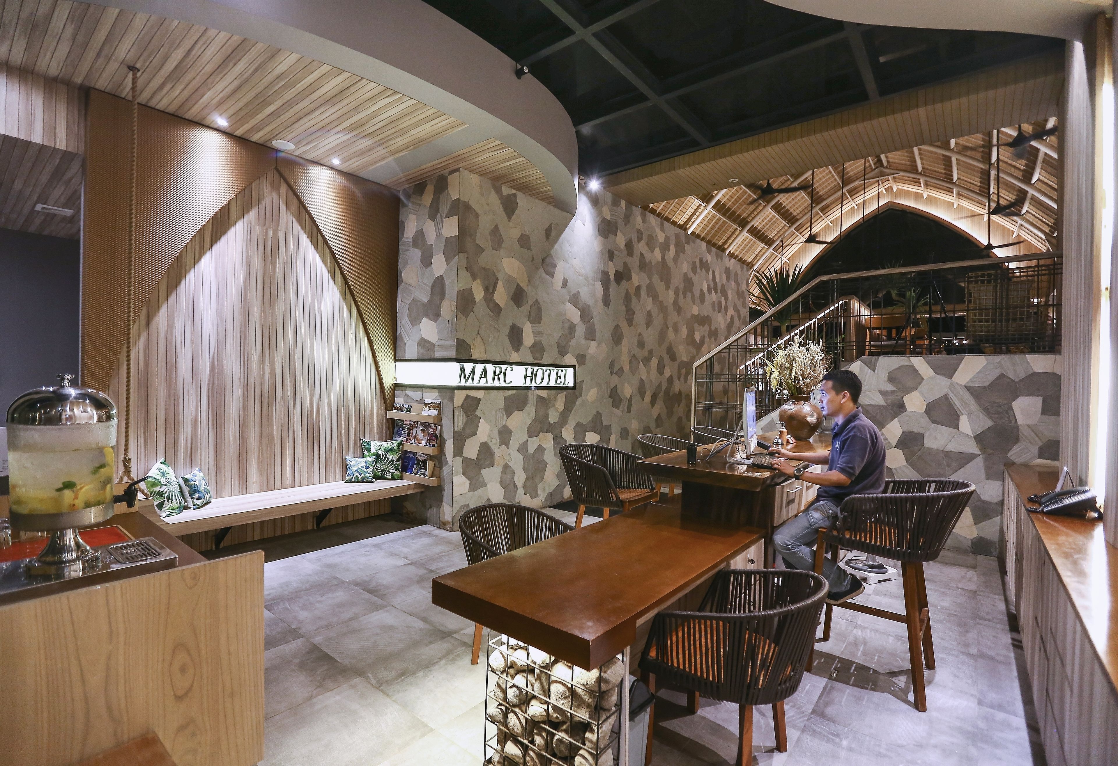 A modern interior with a bar area, wooden accents, and a stone wall.