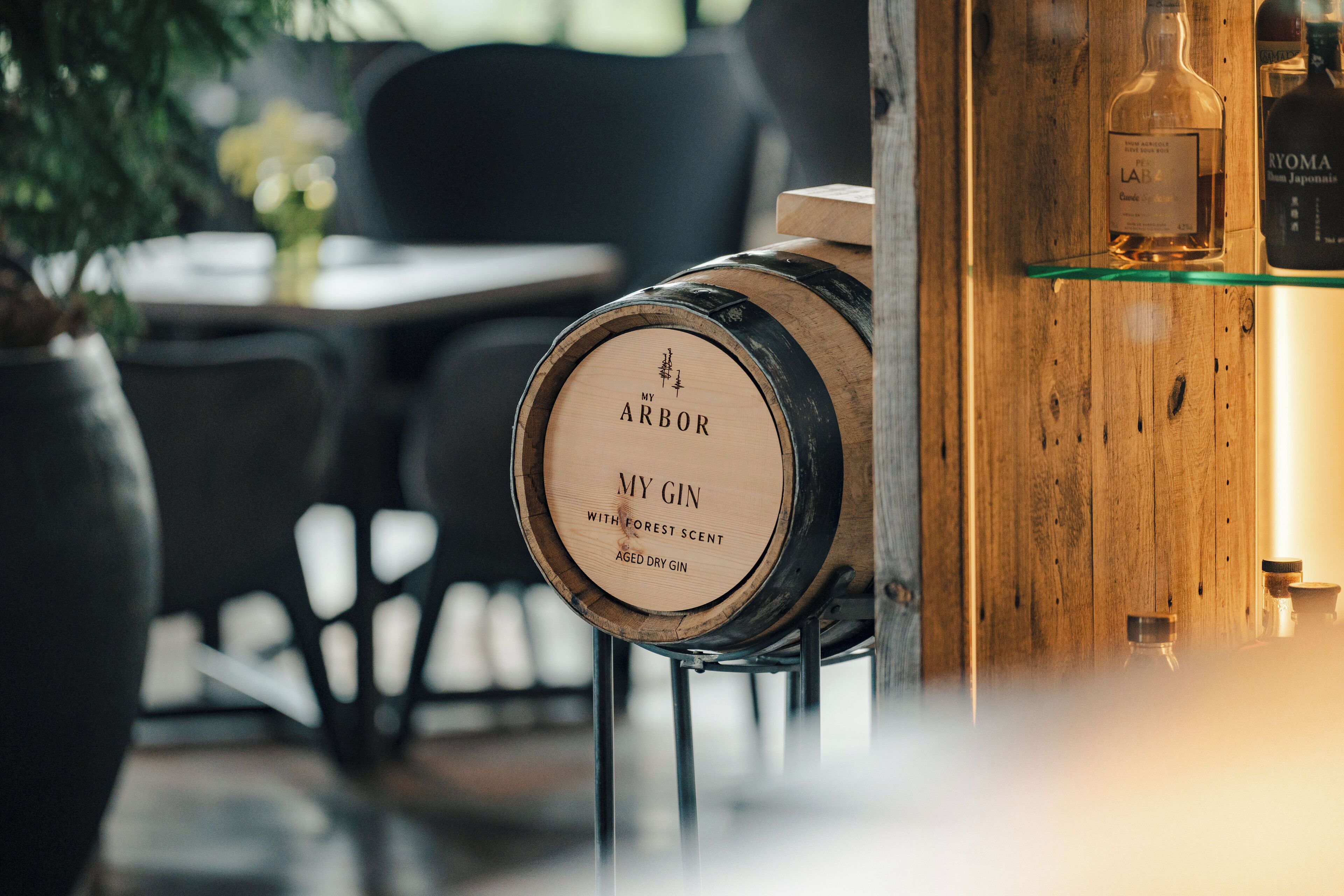 A wooden barrel with a label reading "MY GIN with forest scent".