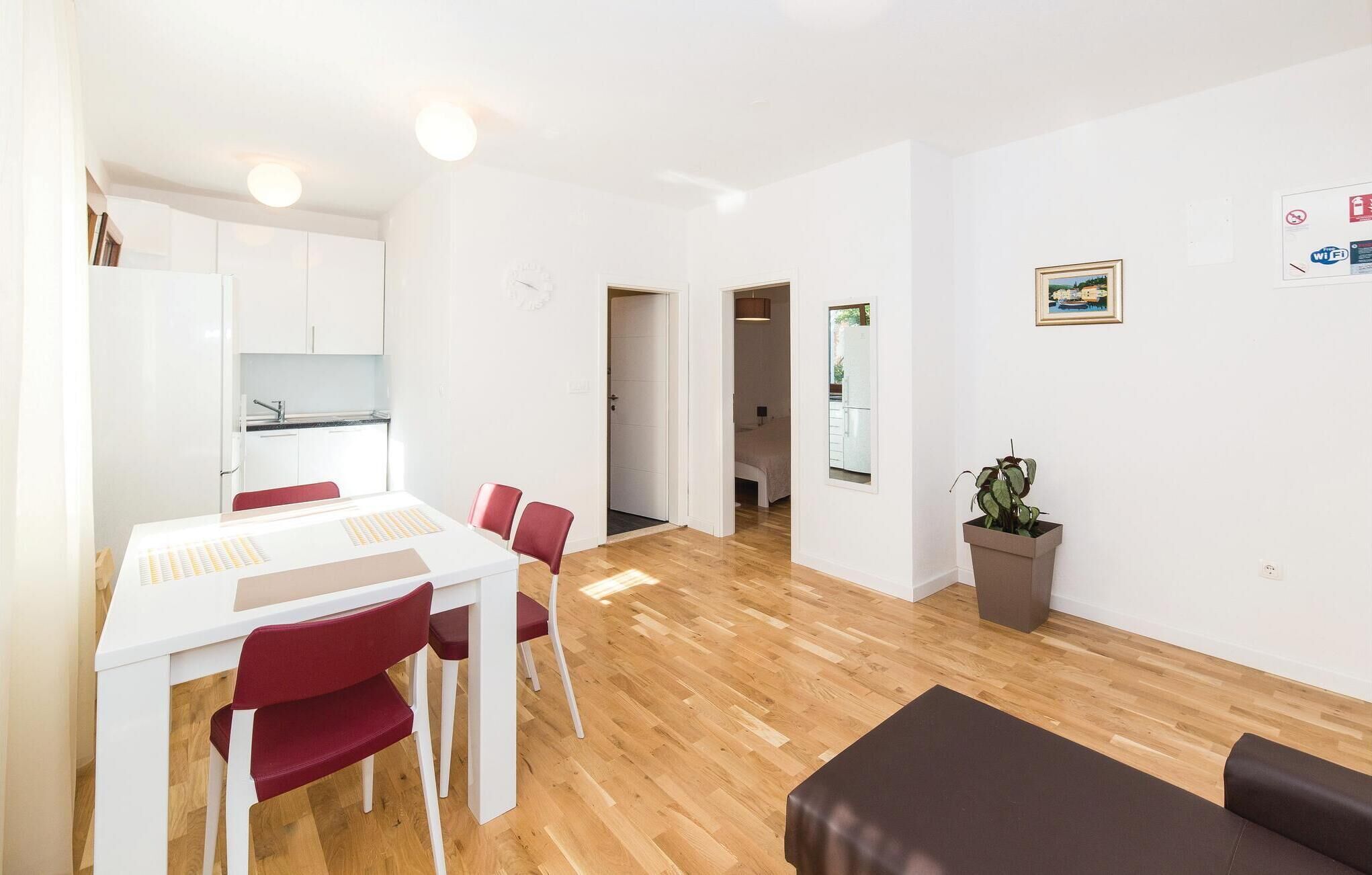 Een modern appartement met een eethoek, keuken en woonkamer met een bank.