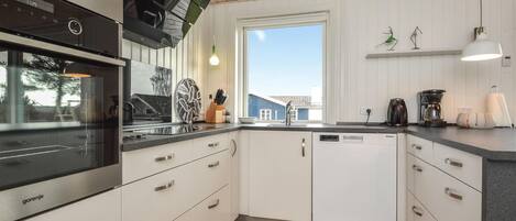 Fridge, stovetop, dishwasher, coffee/tea maker