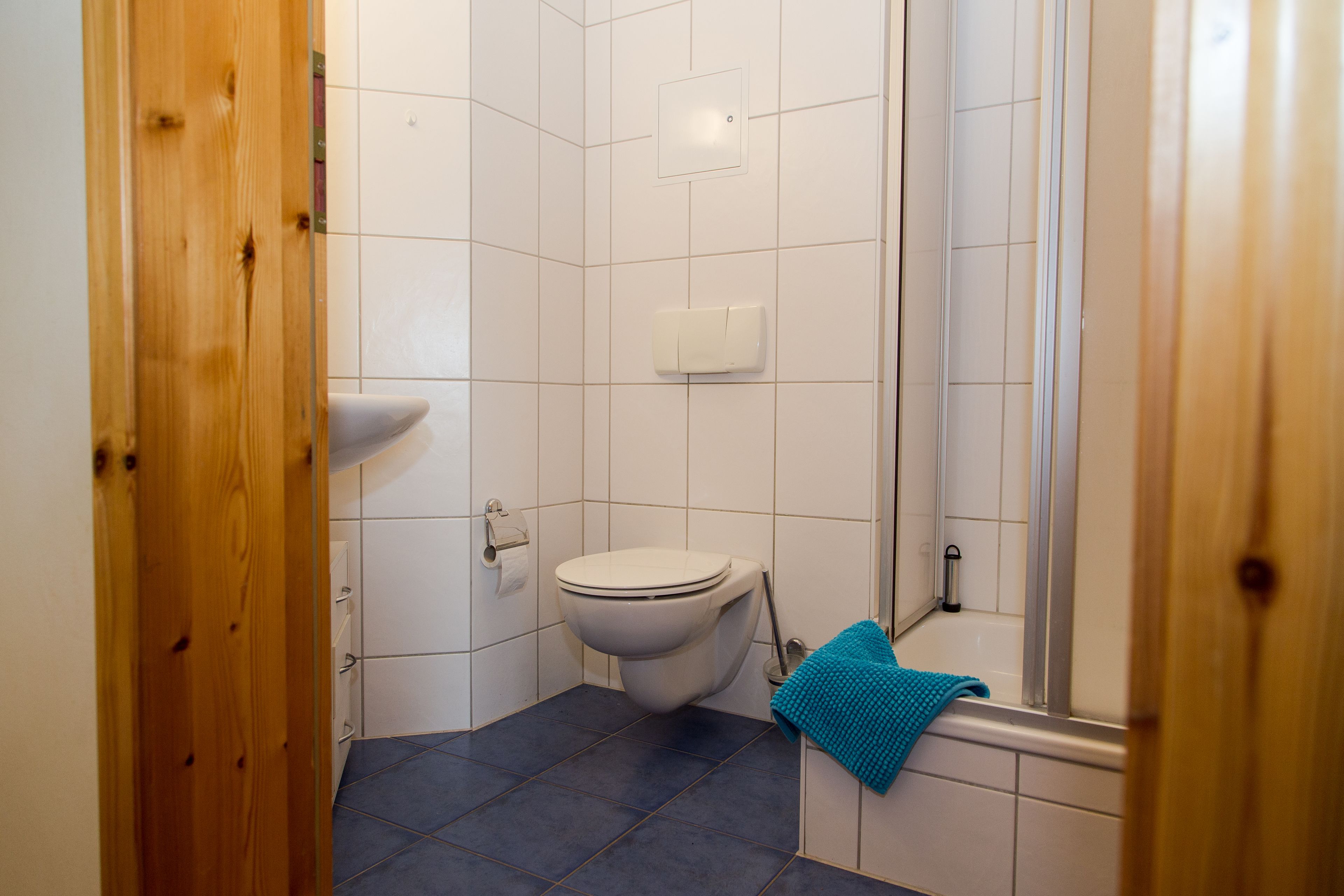 A small bathroom with a toilet, sink, and bathtub.