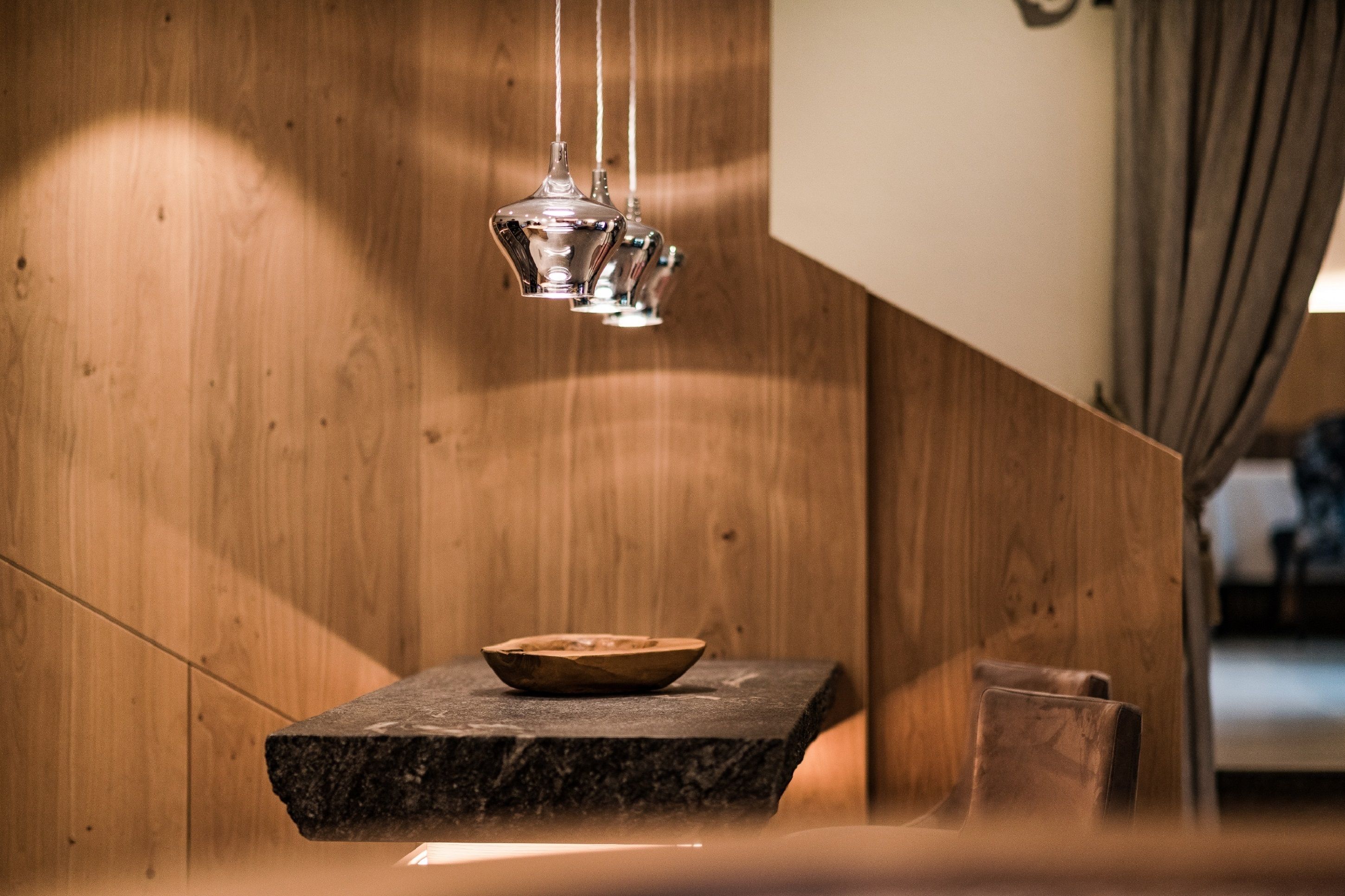 A wooden wall with a stone slab and a bowl on it.
