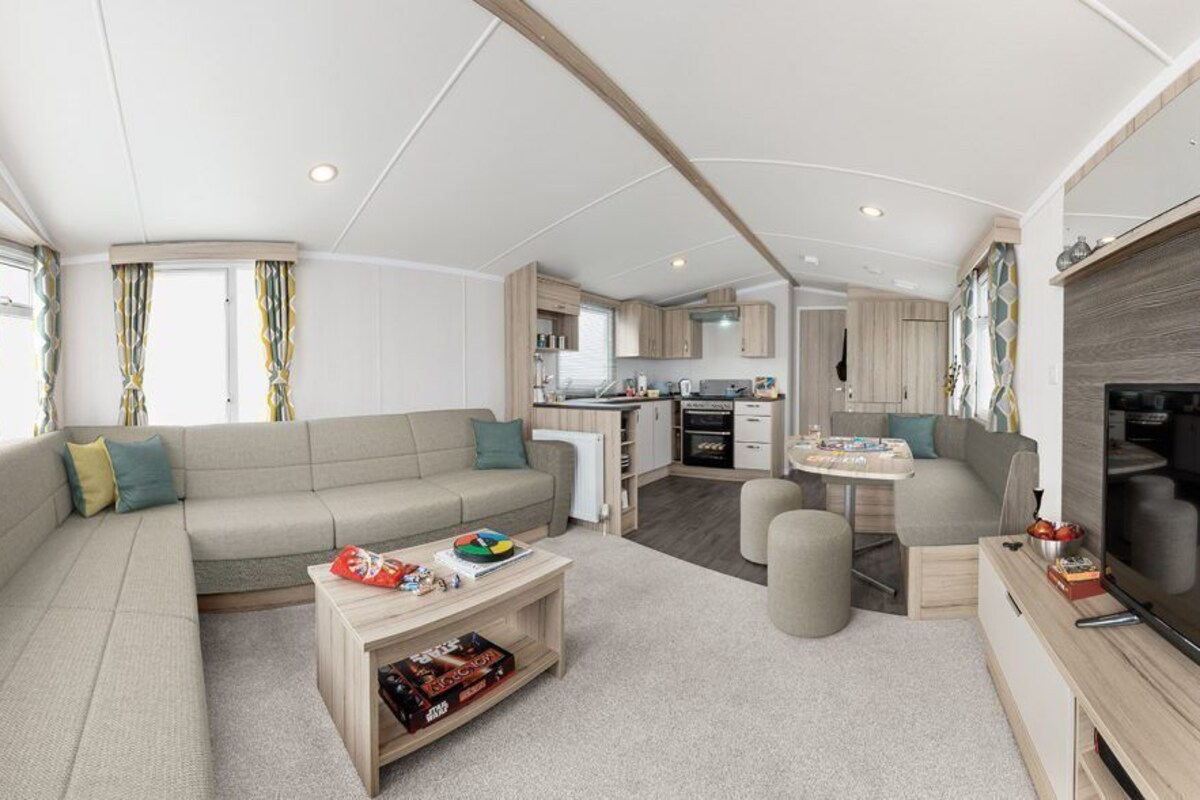 A spacious RV interior with a living area, kitchen, and entertainment space.