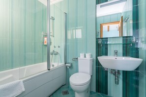 A modern bathroom with a glass shower enclosure, a white toilet, and a sink with a mirror above it. - Villa Zlata (Zupa dubrovacka)