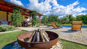 A patio with a fire pit, lounge chairs, and a pool. - Lovely home in Pula with WiFi (Pula)