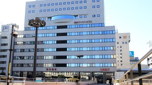 A multi-story building with a modern design, featuring a prominent sign for the "Takasaki Urban Hotel" at the top. - Takasaki Urban Hotel (Takasaki)
