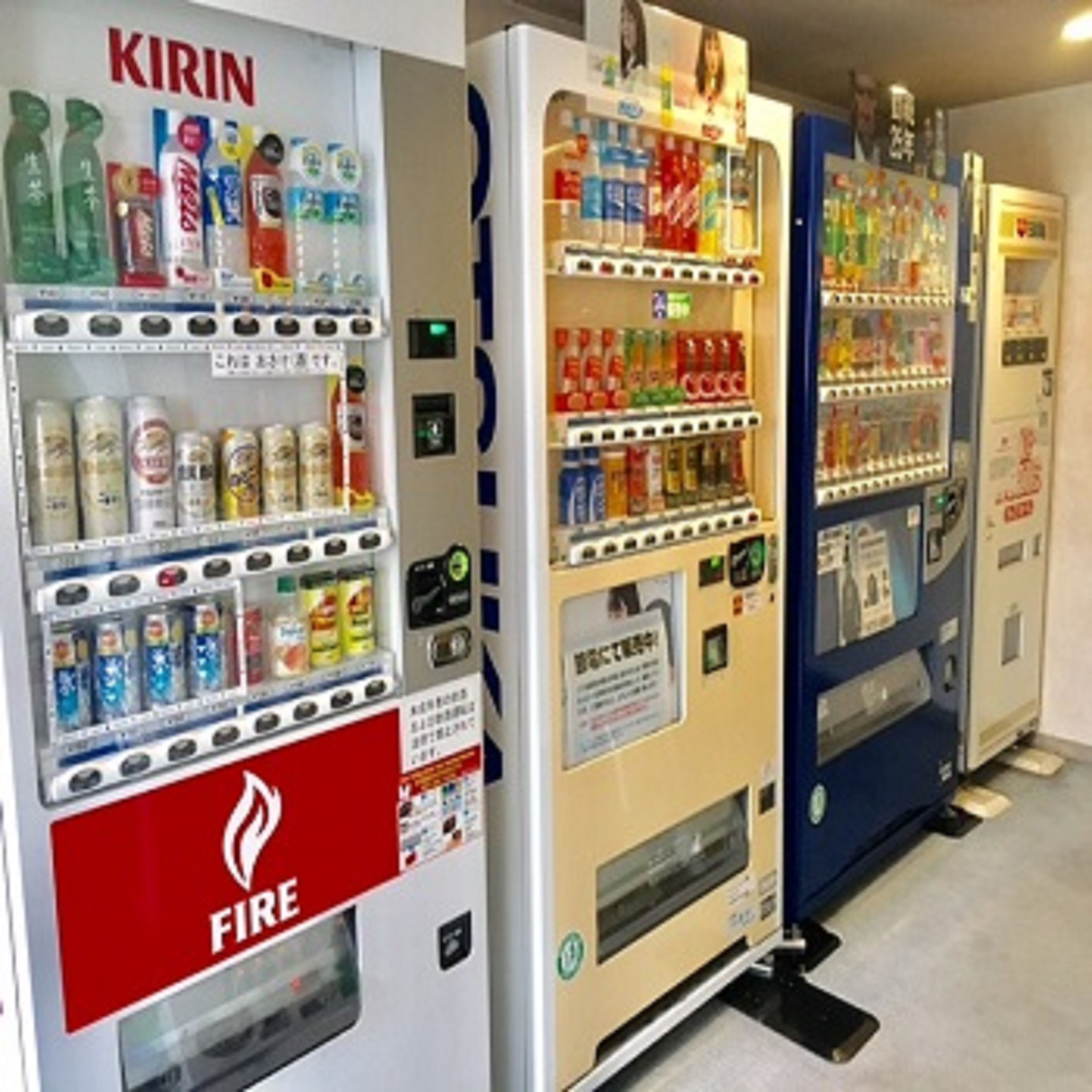 Three vending machines with various beverages and snacks.