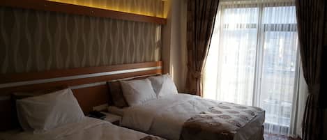 Triple Room | Minibar, in-room safe, desk, iron/ironing board