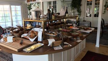 A buffet setup with various food items and a coffee station.