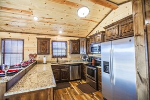 Enjoy cooking in this well-equipped kitchen with a refrigerator, oven, and dishwasher.
