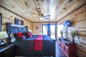 Cozy room with a large bed, nightstand, and TV, set amidst a simple layout.