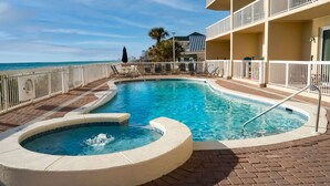 A pool area with a hot tub, lounge chairs, and a view of the ocean. - 😎 Sun, Fun, Beach and Sand😎  FREE Beach Chairs!!  3 payments available Book now  (Panama City)
